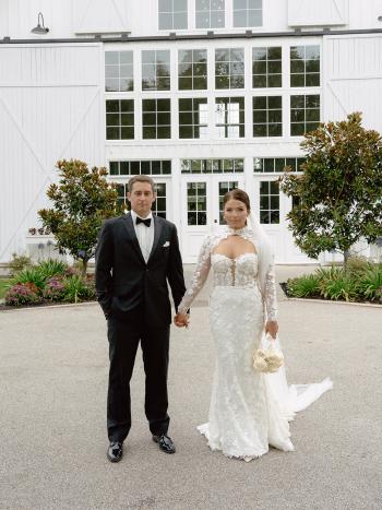 London wedding gown real bride in front of modern barn Kelsi + Blake